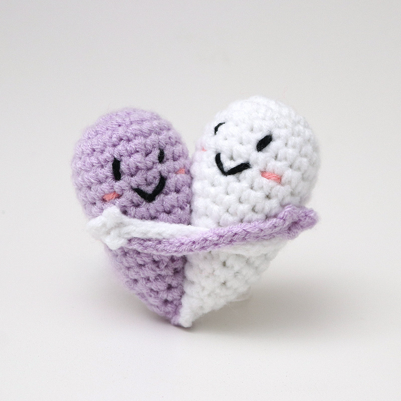 Cute handmade crocheted positive energy doll heart hug emoji pack, a knitted gift for couples.