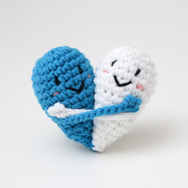 Cute handmade crocheted positive energy doll heart hug emoji pack, a knitted gift for couples.